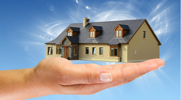house-in-hand-with-blue-background